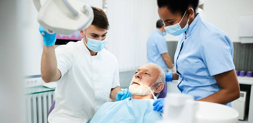 Dental practitioners with a patient in the dental chair